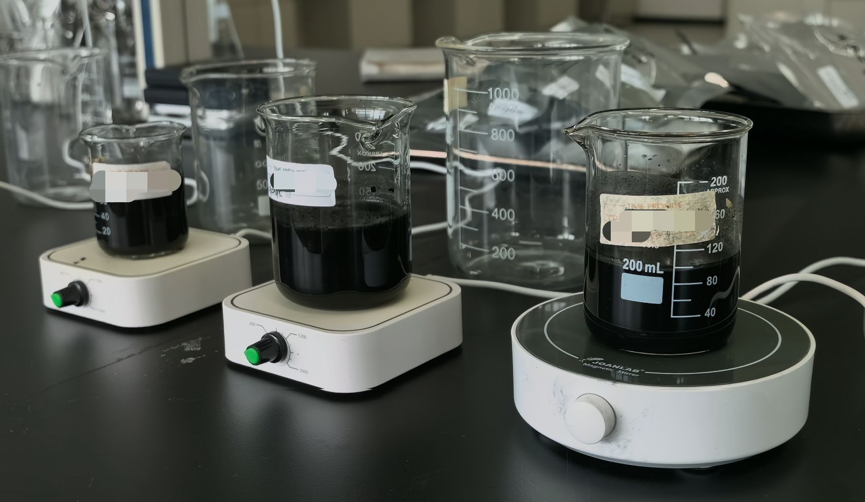 Chemical extraction process in laboratory beakers for purifying antique camphor wood carbon