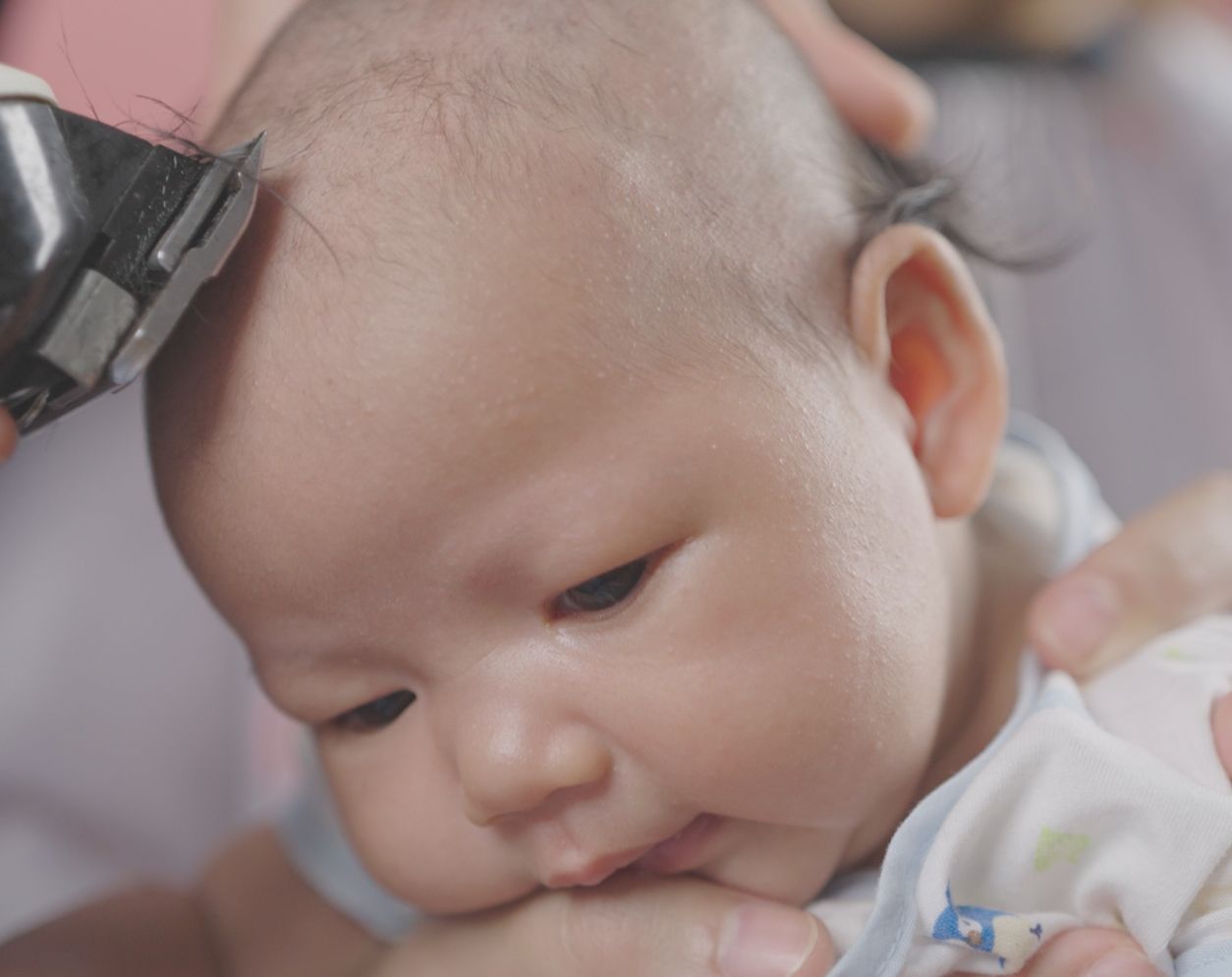 Baby's first haircut during the traditional Chinese 100-day ceremony