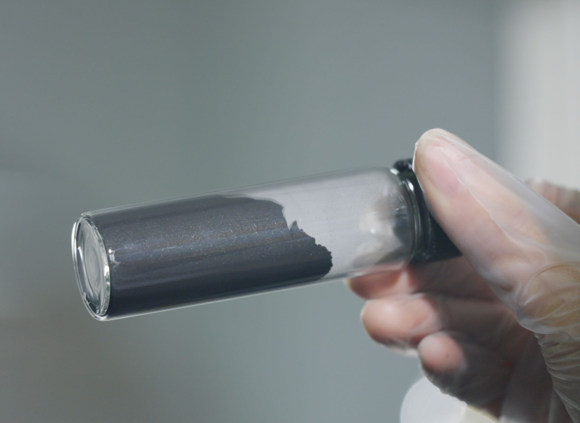 Purified carbon powder in glass vial — first extraction result from sorghum grain