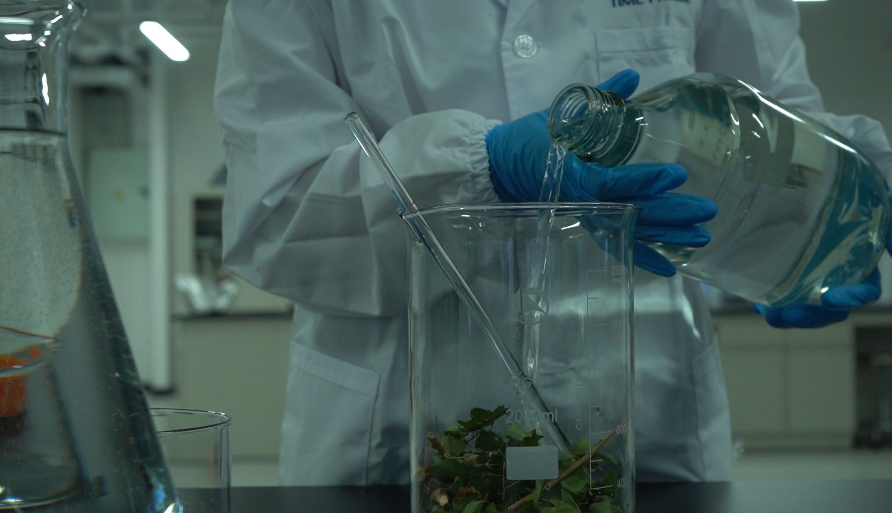 Close-up of extraction solution being poured in laboratory