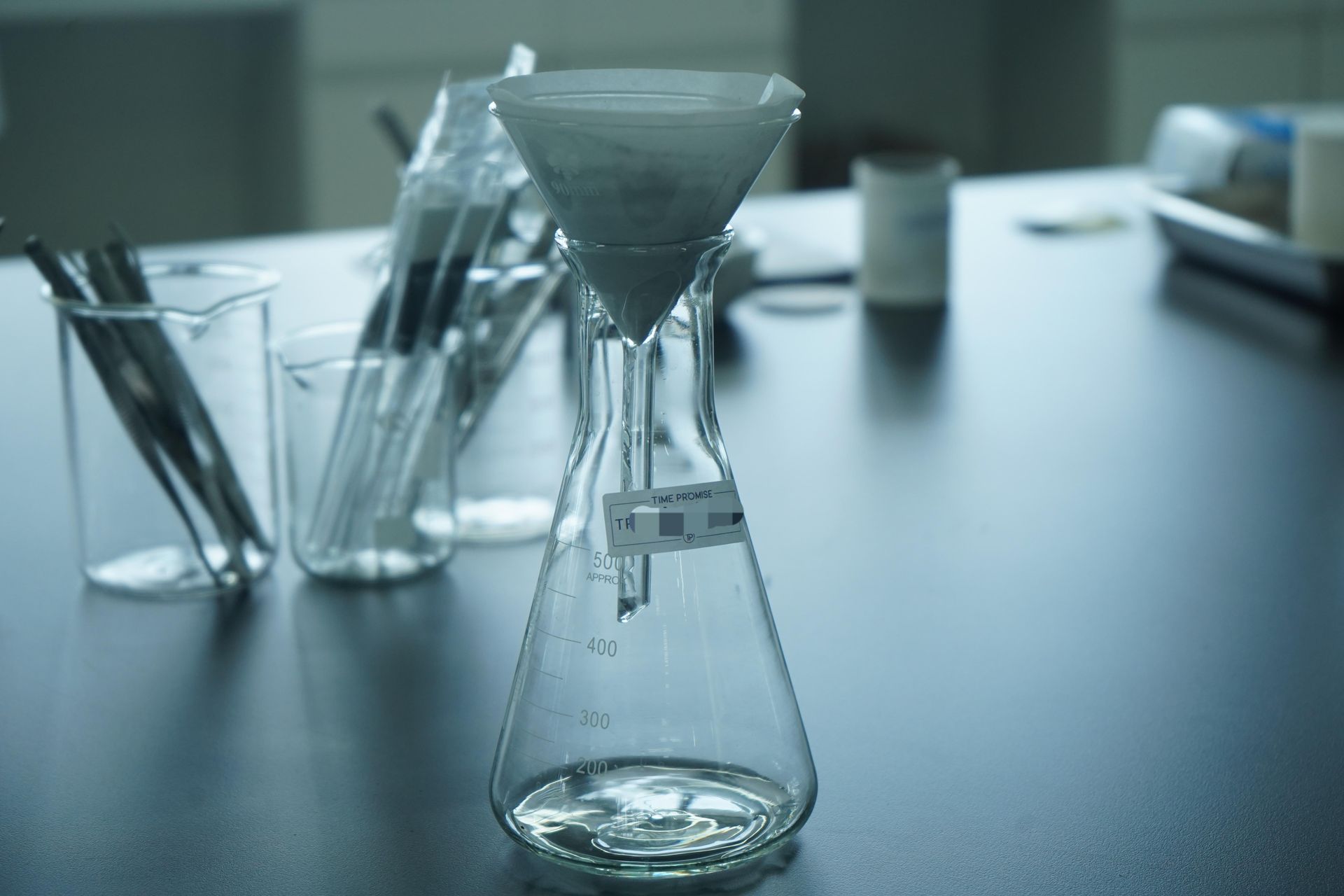 Plant material being ground with mortar and pestle in laboratory