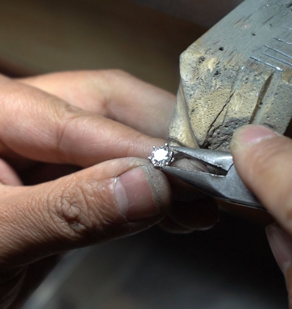 Hand-setting a brilliant-cut memorial diamond into its final setting — irreversible personalization at the bench