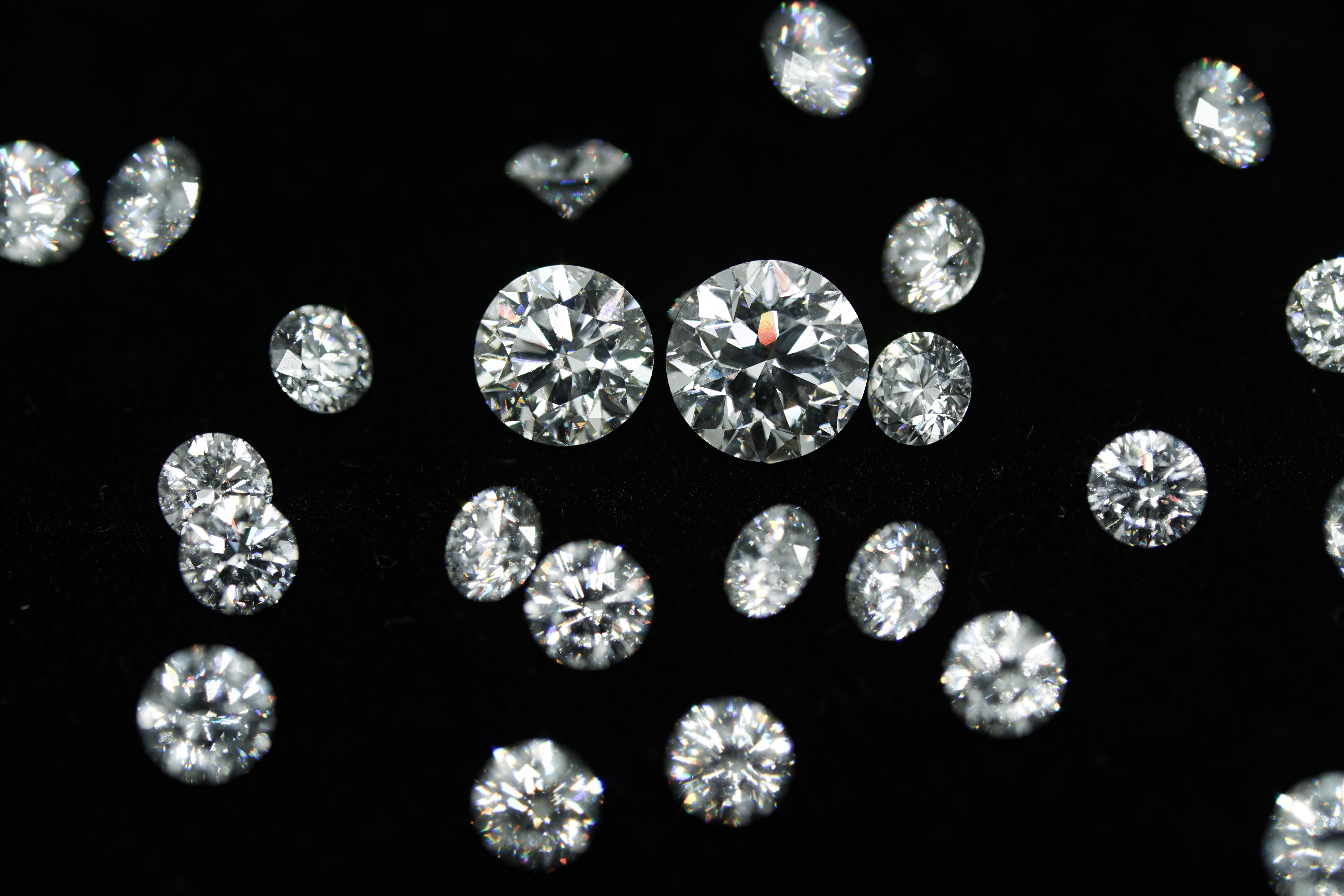 Diamond collection display showing multiple memorial diamonds under laboratory lighting