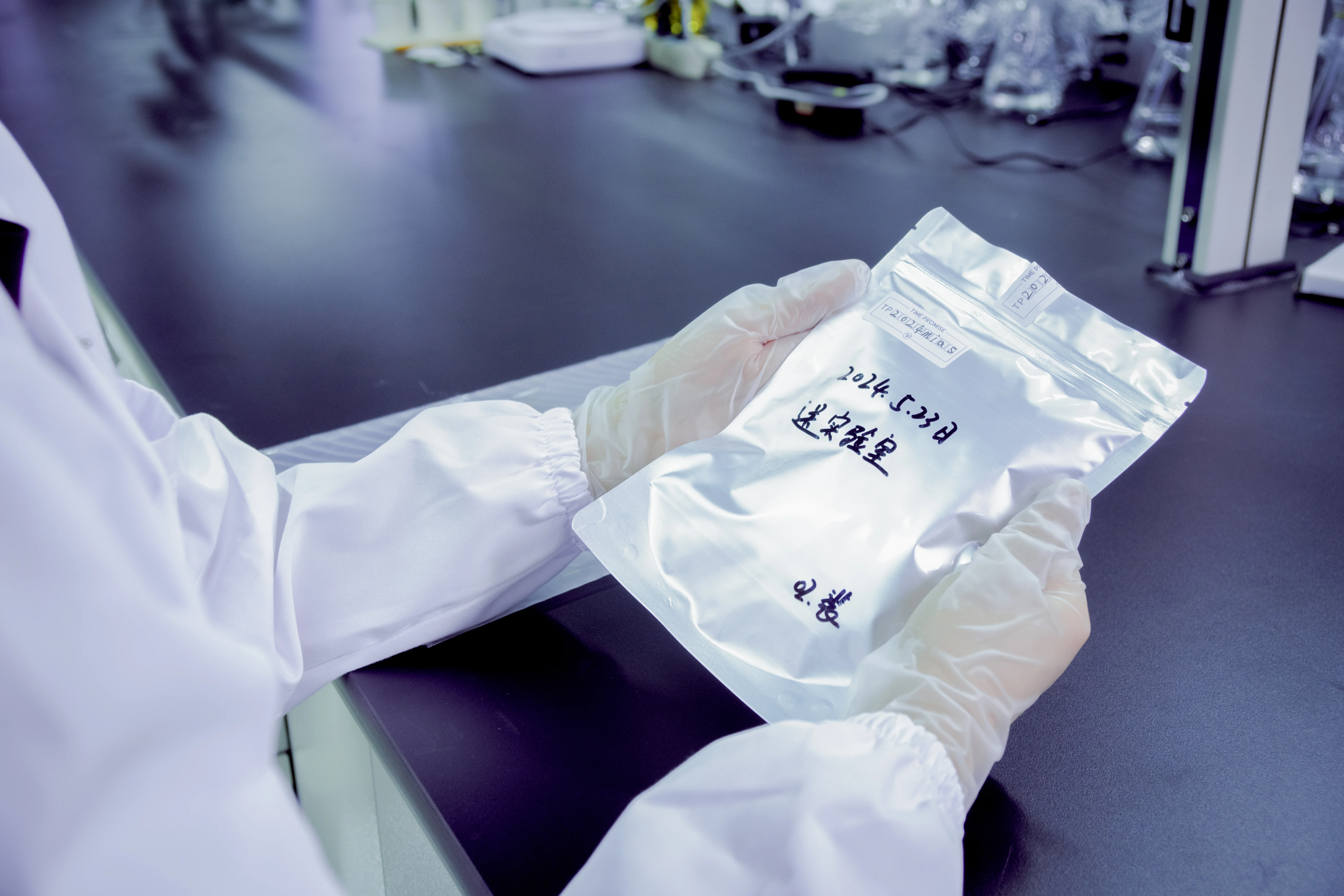 Laboratory technician handling hair sample for carbon extraction process — memorial diamond manufacturing