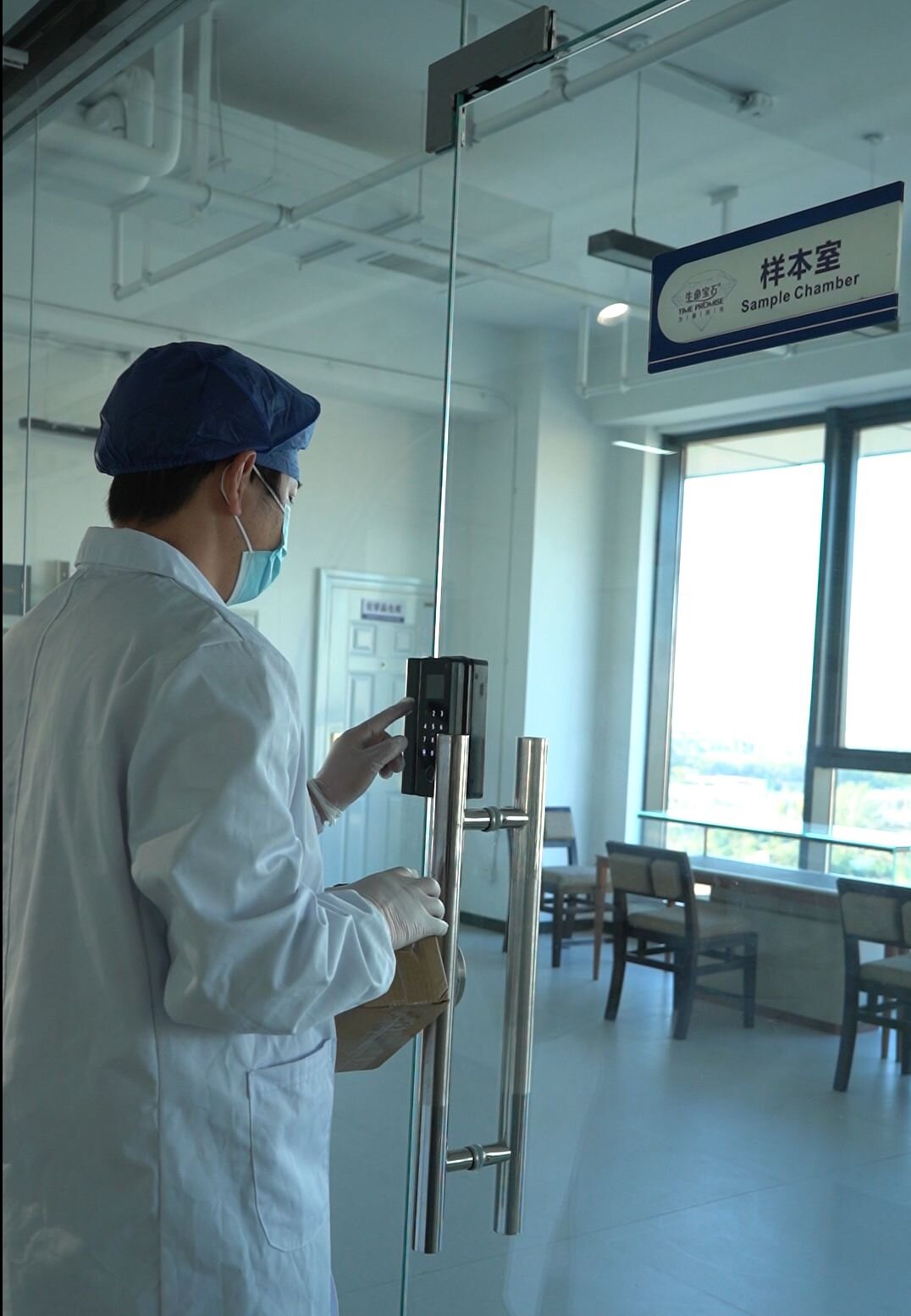 Technician entering a segregated sample processing chamber, demonstrating controlled custody lanes in a memorial diamond factory