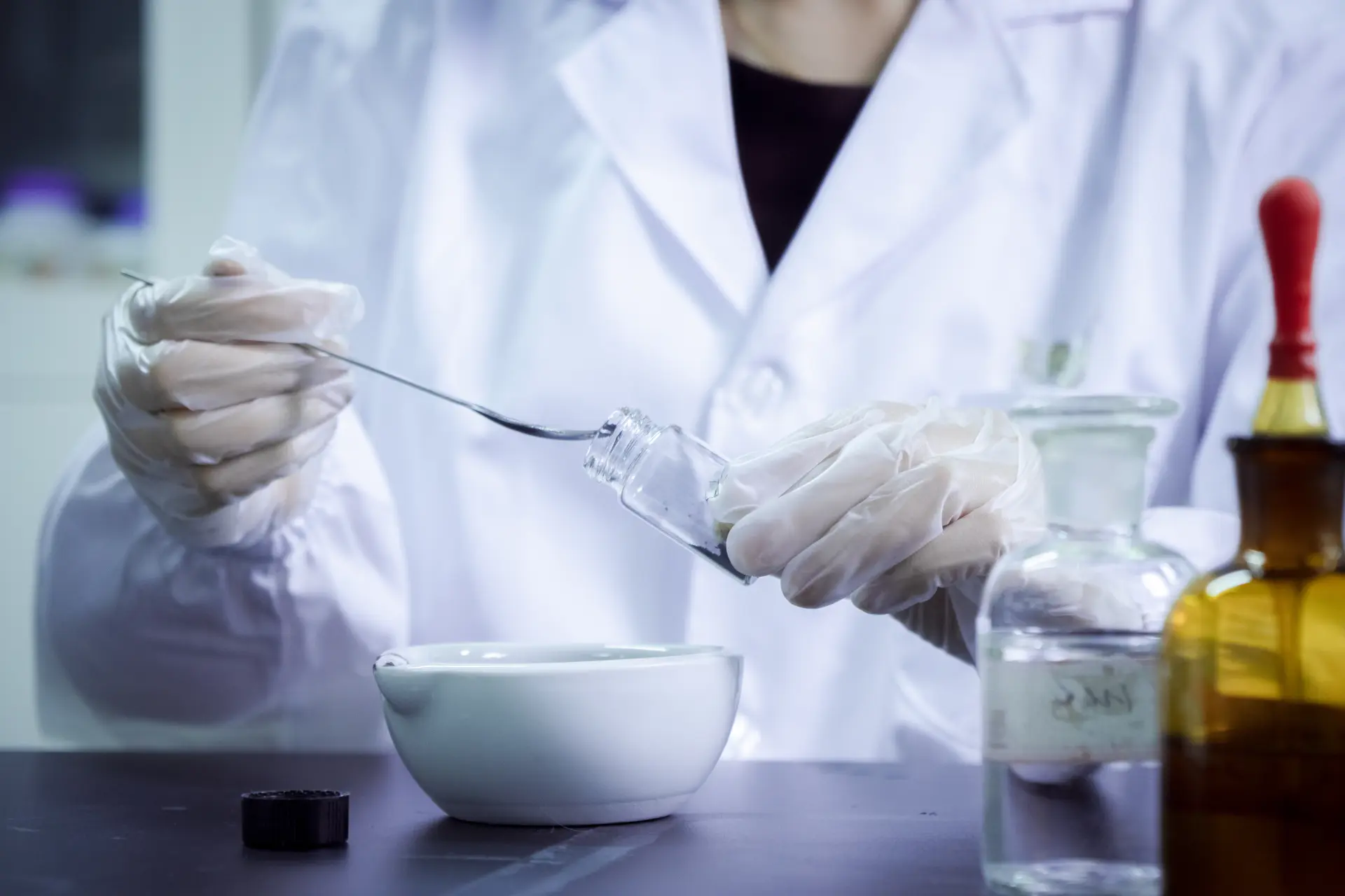 Laboratory technician inspecting carbon sample vial during purification quality control