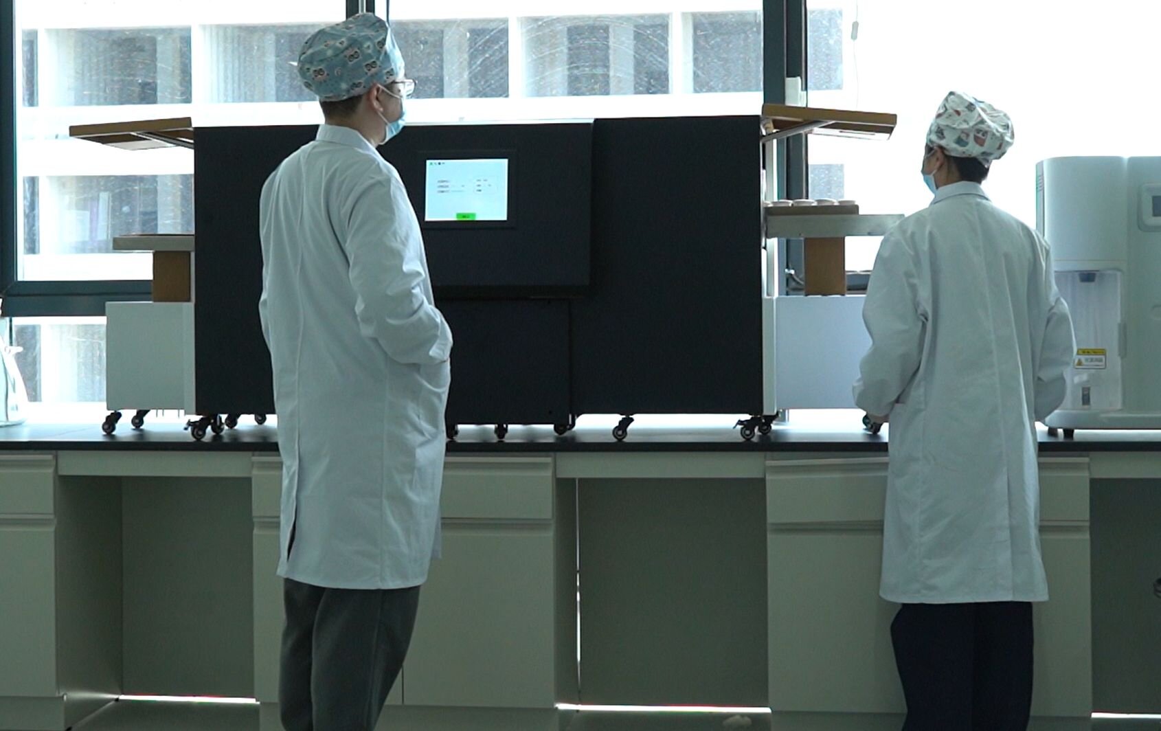 Technicians operating HPHT synthesis equipment under extreme pressure conditions