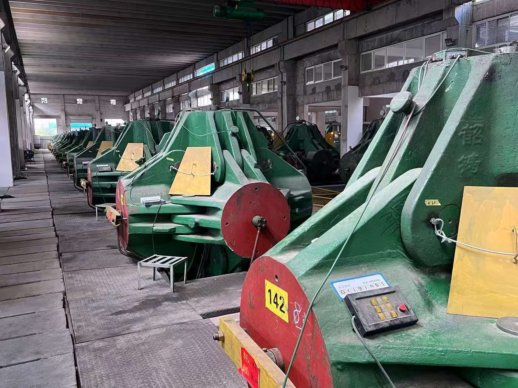 Row of green six-sided HPHT cubic presses in the BioGem Lab synthesis hall