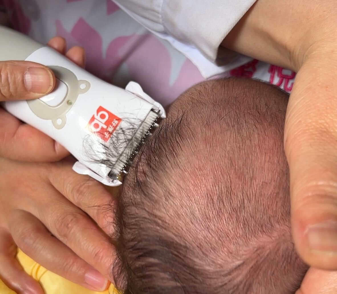 Close-up of the hair clipper used for the baby's first haircut